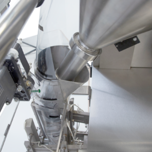 Primer plano del alimentador y del formador de bolsas en una máquina VFFS de JORES TECHNOLOGIES® para el envasado de polvos.