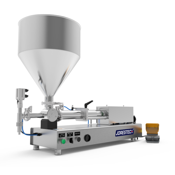 Una máquina llenadora de pasta de alta viscosidad con pistón. El llenador de pistón está fabricado en acero inoxidable y hay un pedal amarillo y gris apoyado en el lateral.
