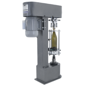 envasadora de botellas de sobremesa gris con una botella de vino verde insertada. La envasadora está colocando una tapa metálica sobre la parte superior de la botella.