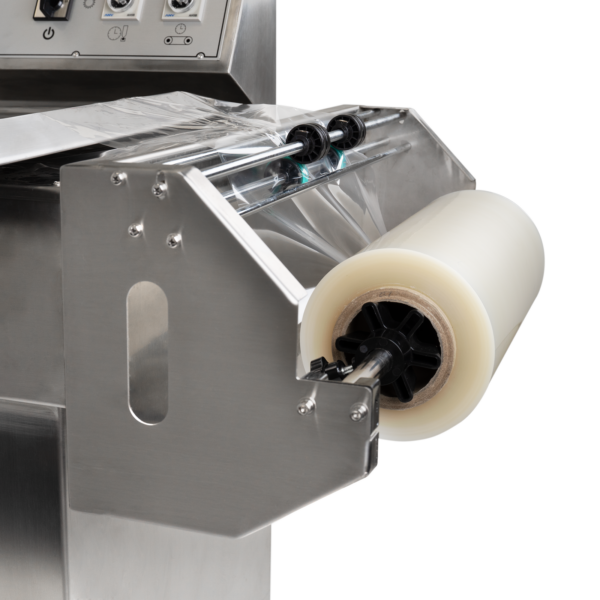 Rollo de film retráctil colocado sobre la selladora térmica semiautomática L bar de acero inoxidable JORES TECHNOLOGIES® con transportador