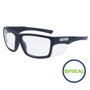 Gafas de seguridad de lectura bifocal JORESTECH con protector lateral transparente para protección de alto impacto. Estas gafas de seguridad tienen montura negra y lentes transparentes de policarbonato. En un dibujo verde y azul se lee bifocal
